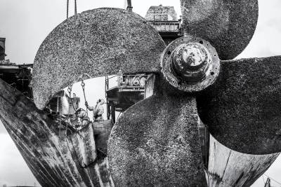 The propeller of M/V OS35 with remains of the Engine room hull on the background during demolishing at the port of Amsterdam.