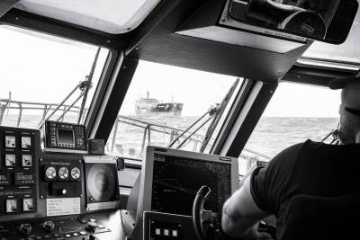Approach of pilot boat to a tanker at the Northsea near IJmuiden (Port of Amsterdam).